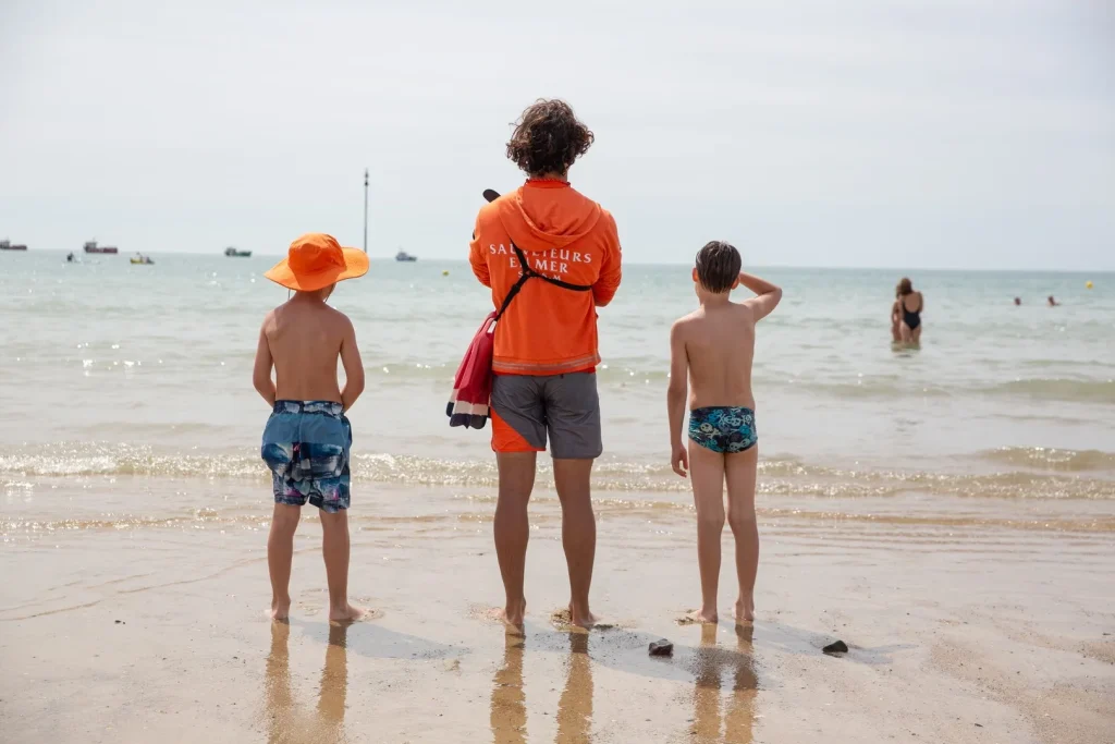Sea lifeguard and children at Pirou Plage